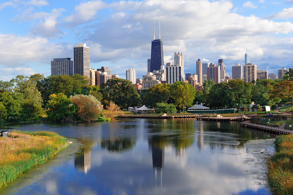 Chicago skyline with skyscrapers viewed from Lincoln Park over lake.