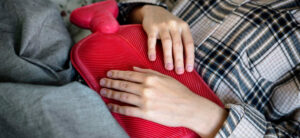 Person holding a hot water bottle