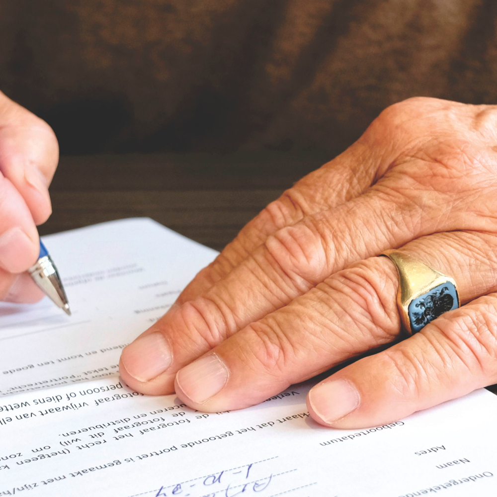 person holding a paper and pen