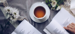 person reading with a cup of tea