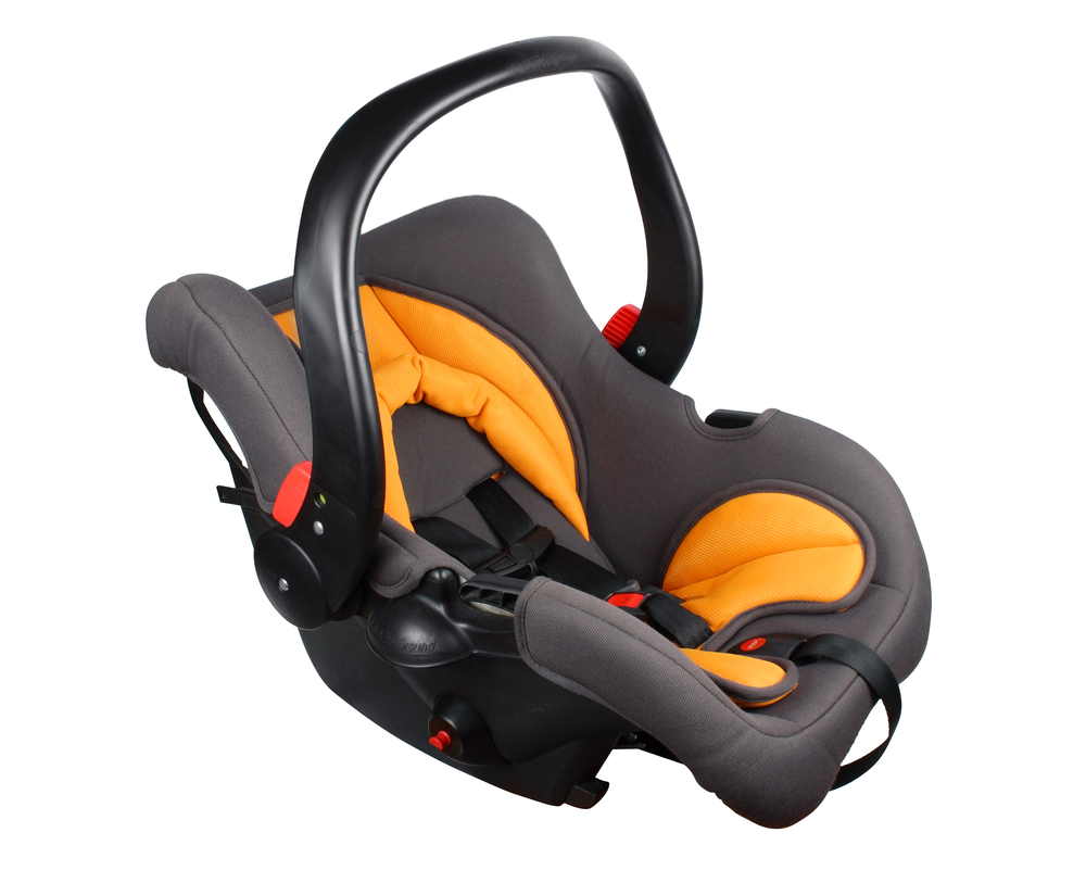 Baby black and orange car seat isolated against a white background