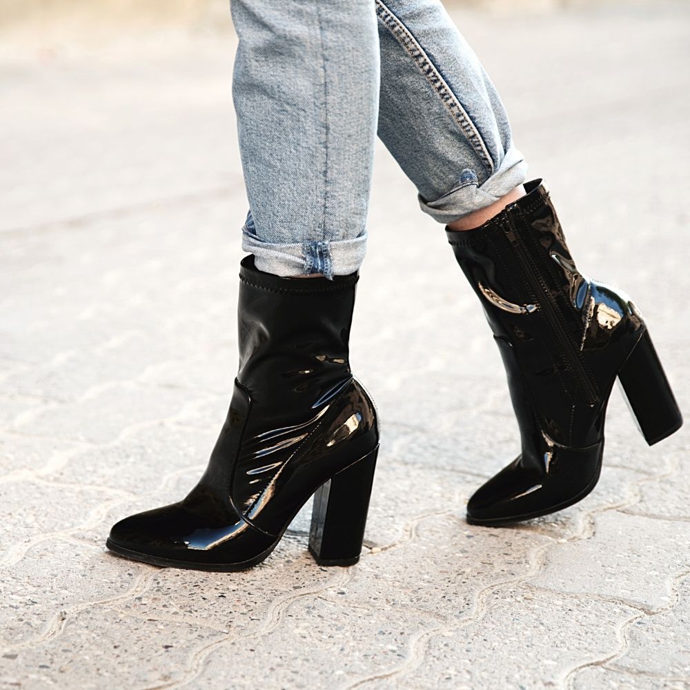 Person walking along wearing a black pair of boots