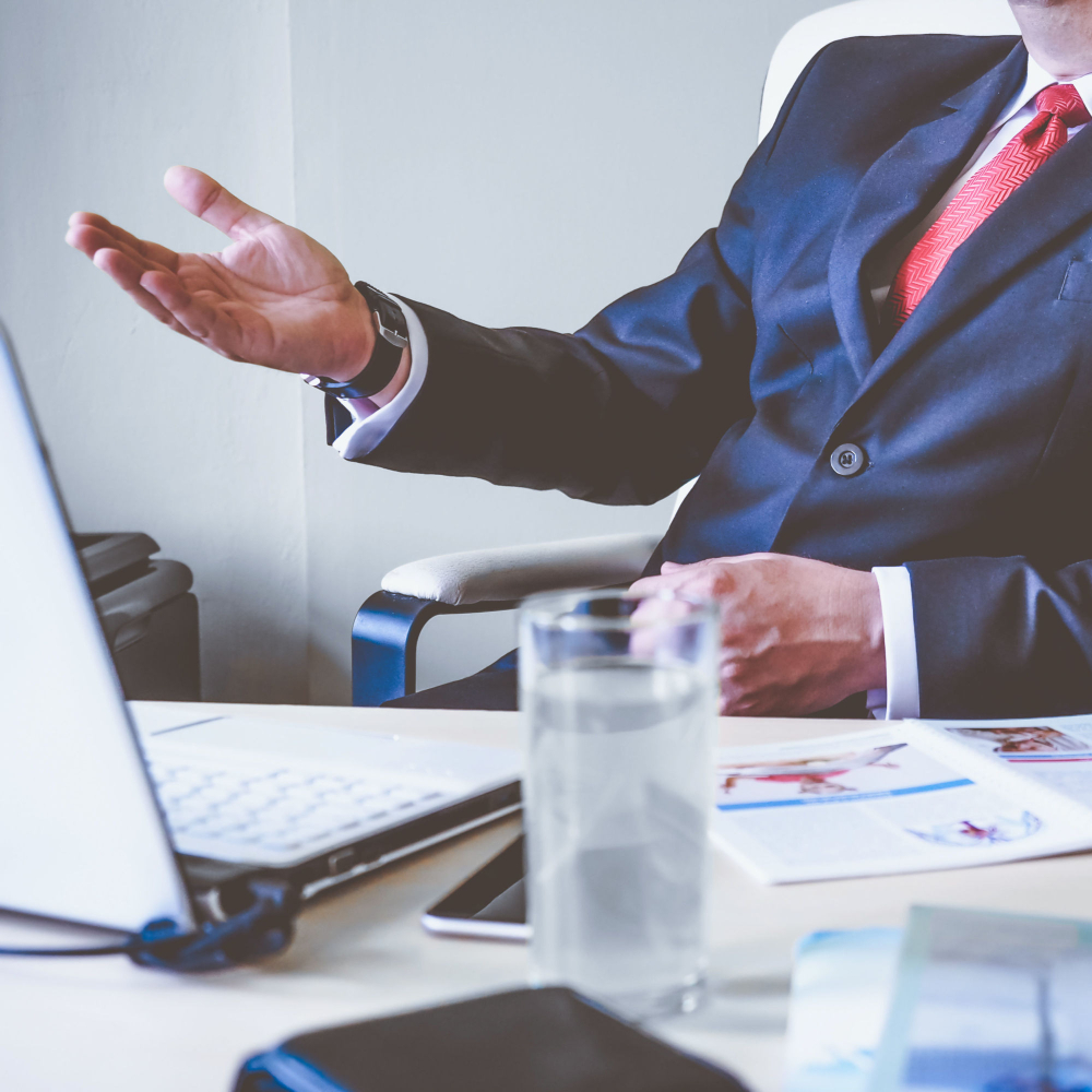 man dressed in a smart suit in a meeting