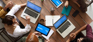People working on their laptops around a table