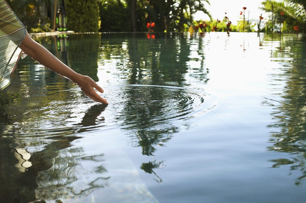 Hand in Pool on Water