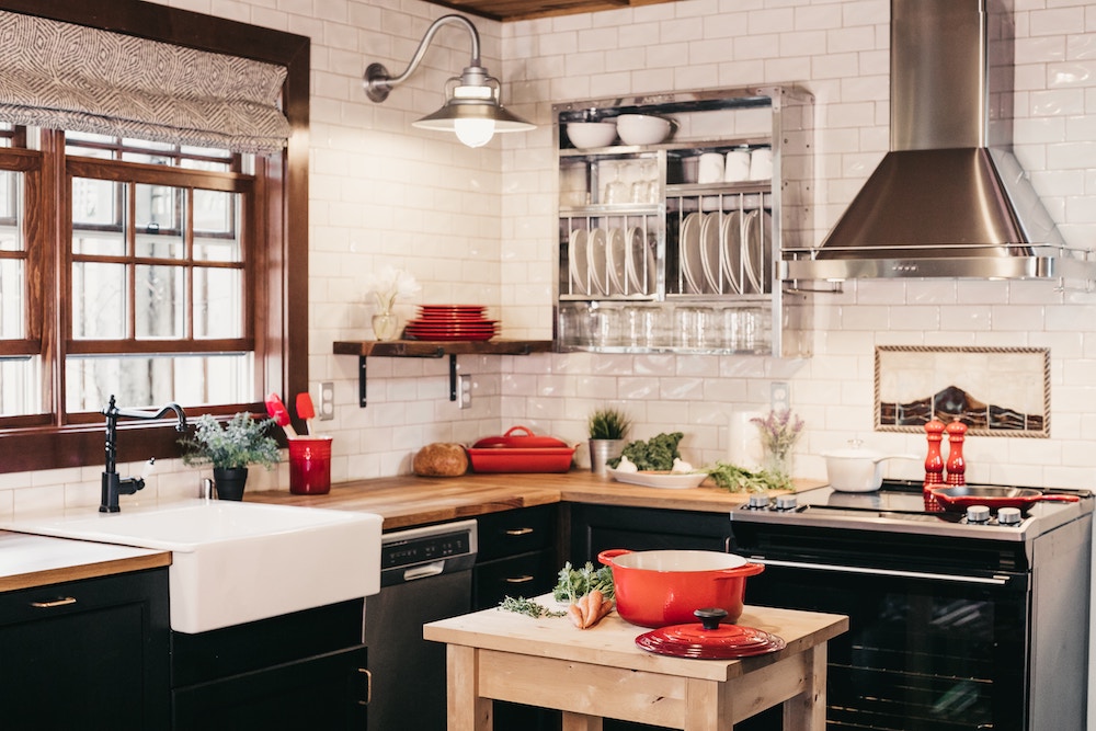A kitchen with black cabinets and wooden elements