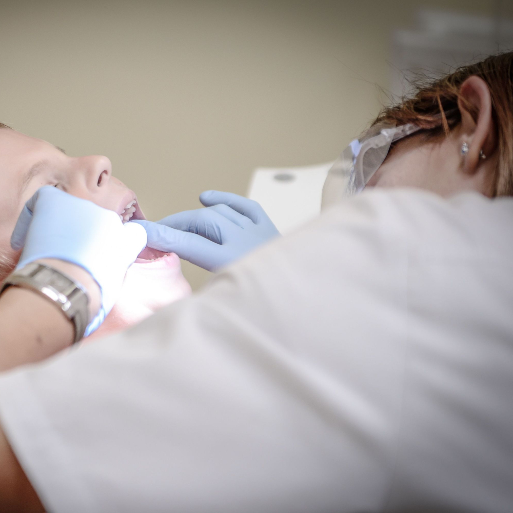 dentist looking in a persons mouth