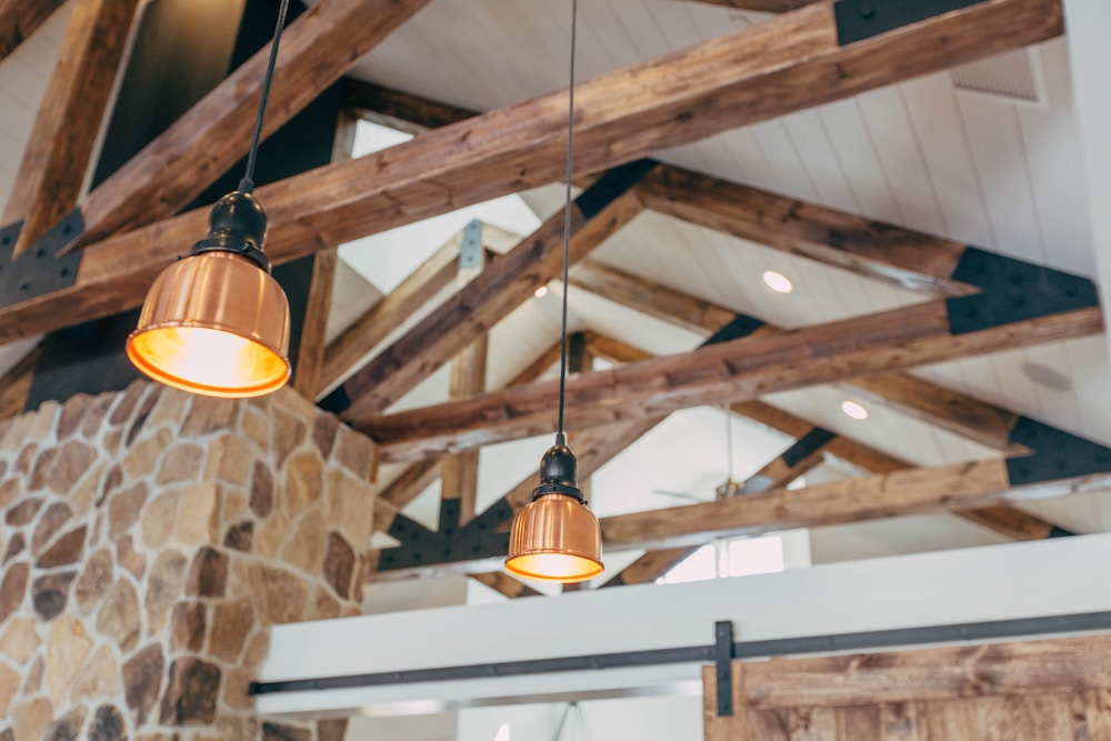 Antique pendant lights hanging from wooden beams
