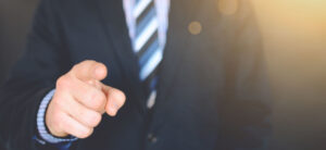 person in suit and tie pointing