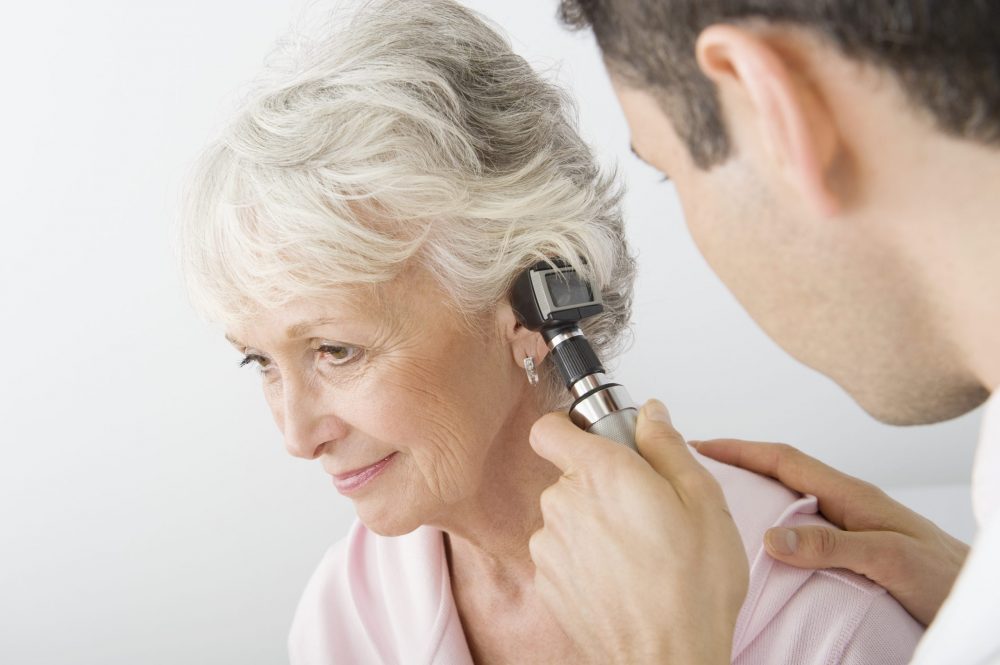 doctor checking a ladies ear