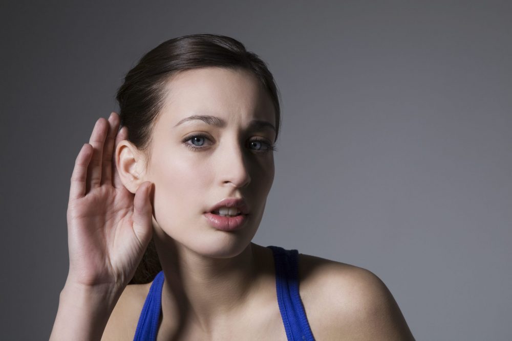 lady with a hand to her ear