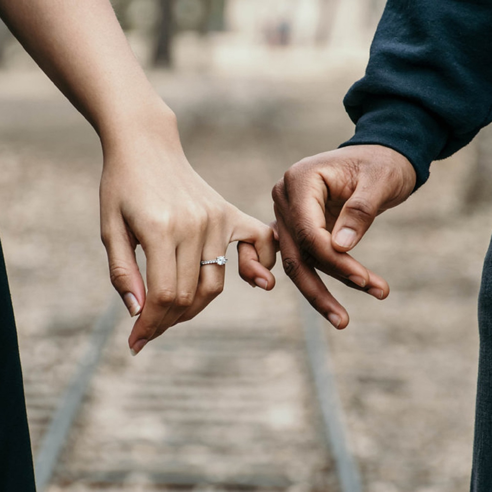 couple with fingers linked