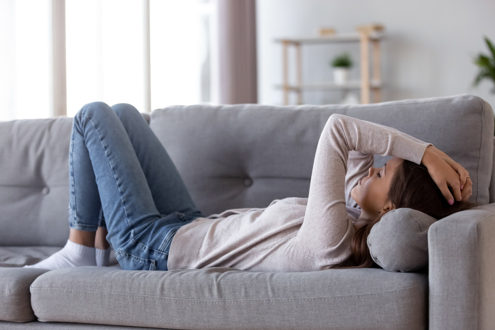 Coping With Fatigue lady laying on a sofa