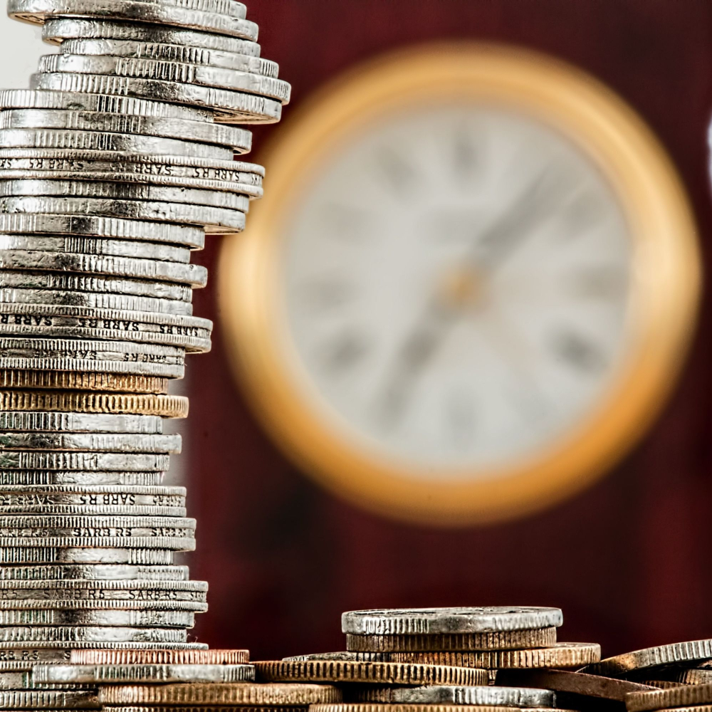 coins with a clock in the background
