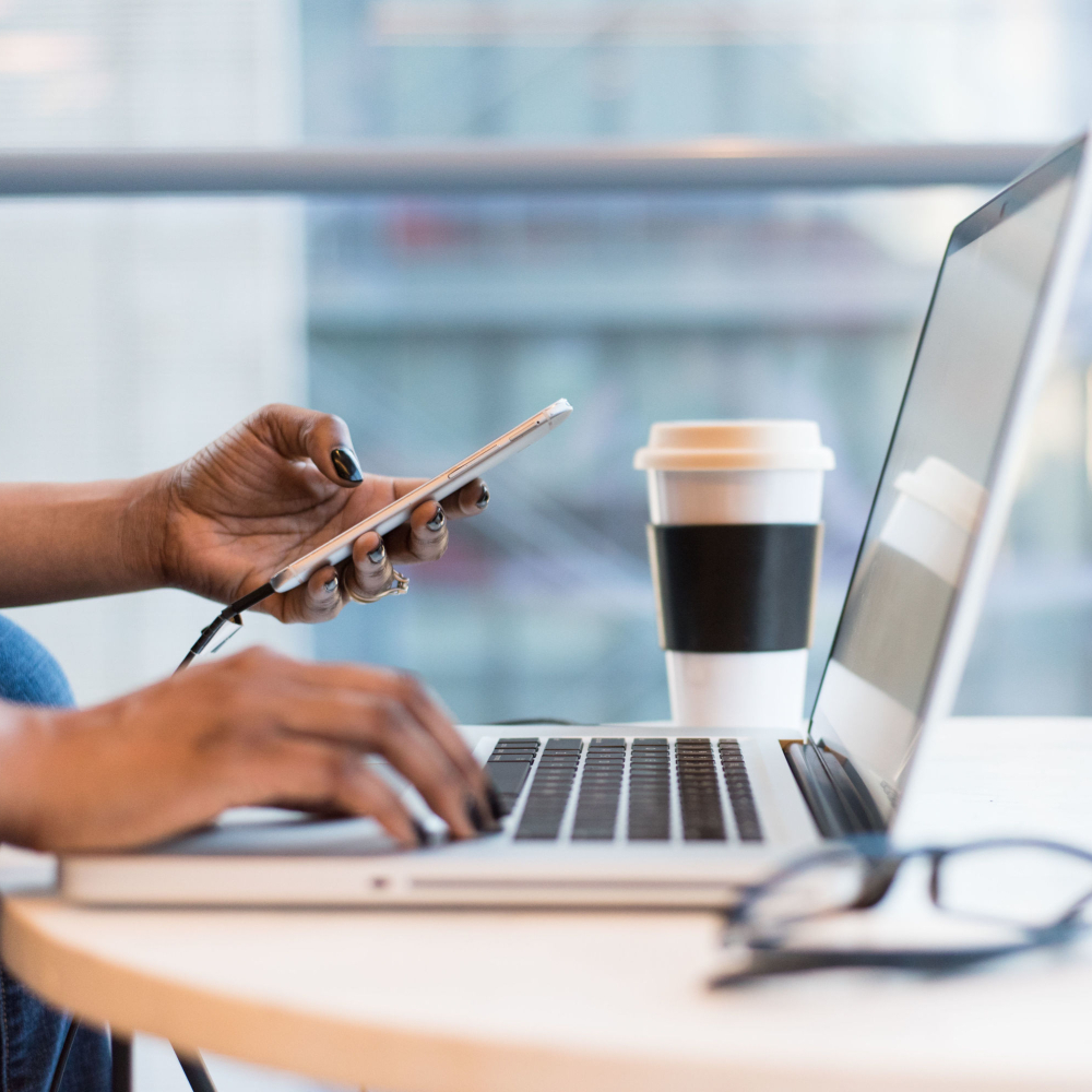 person on phone and laptop