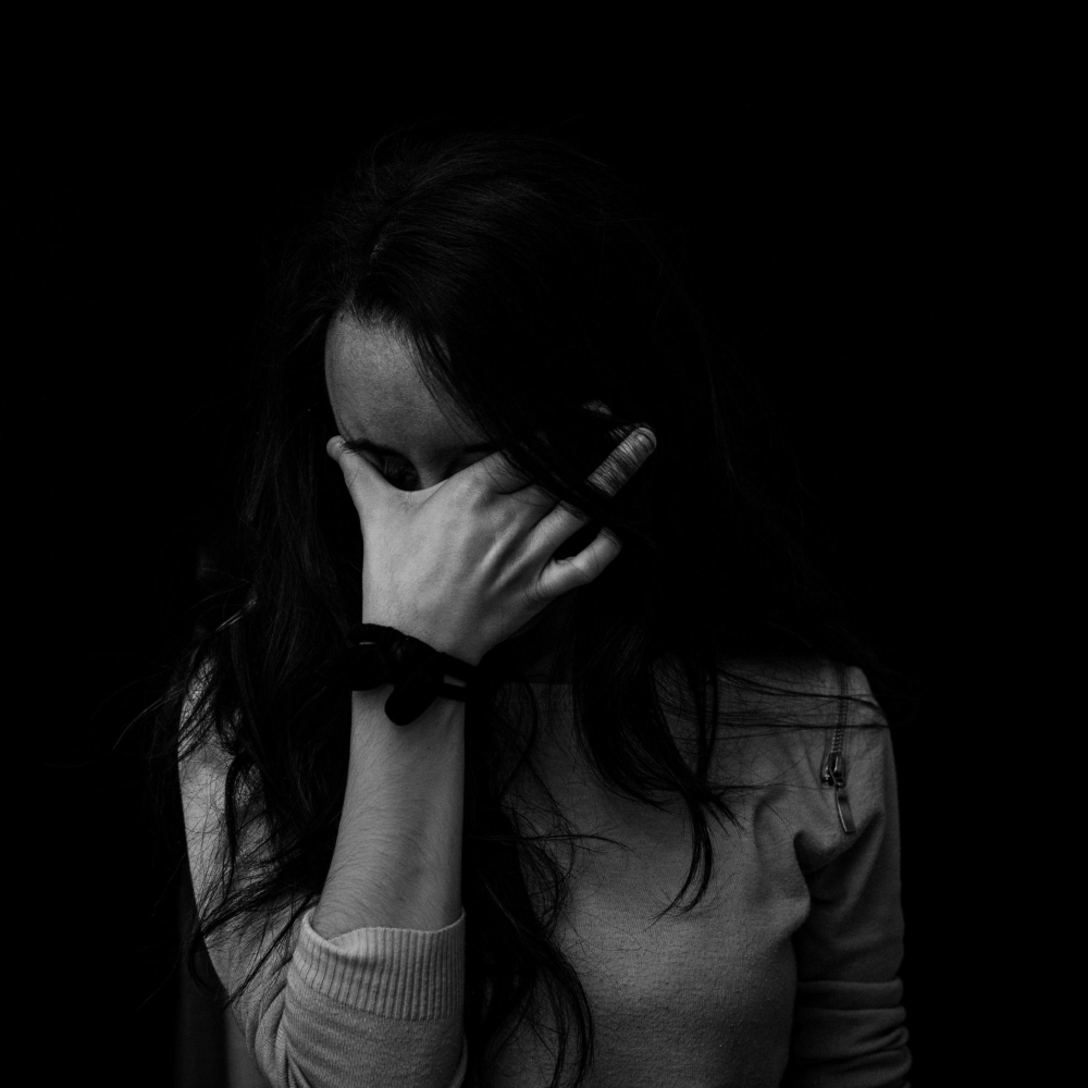 person with their head in their hands
