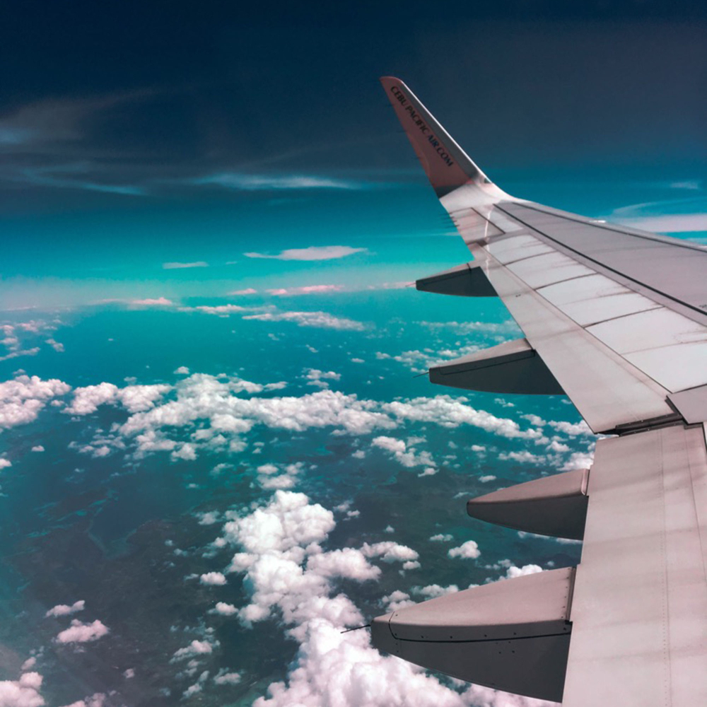 view above the clouds and wing of an aeroplane