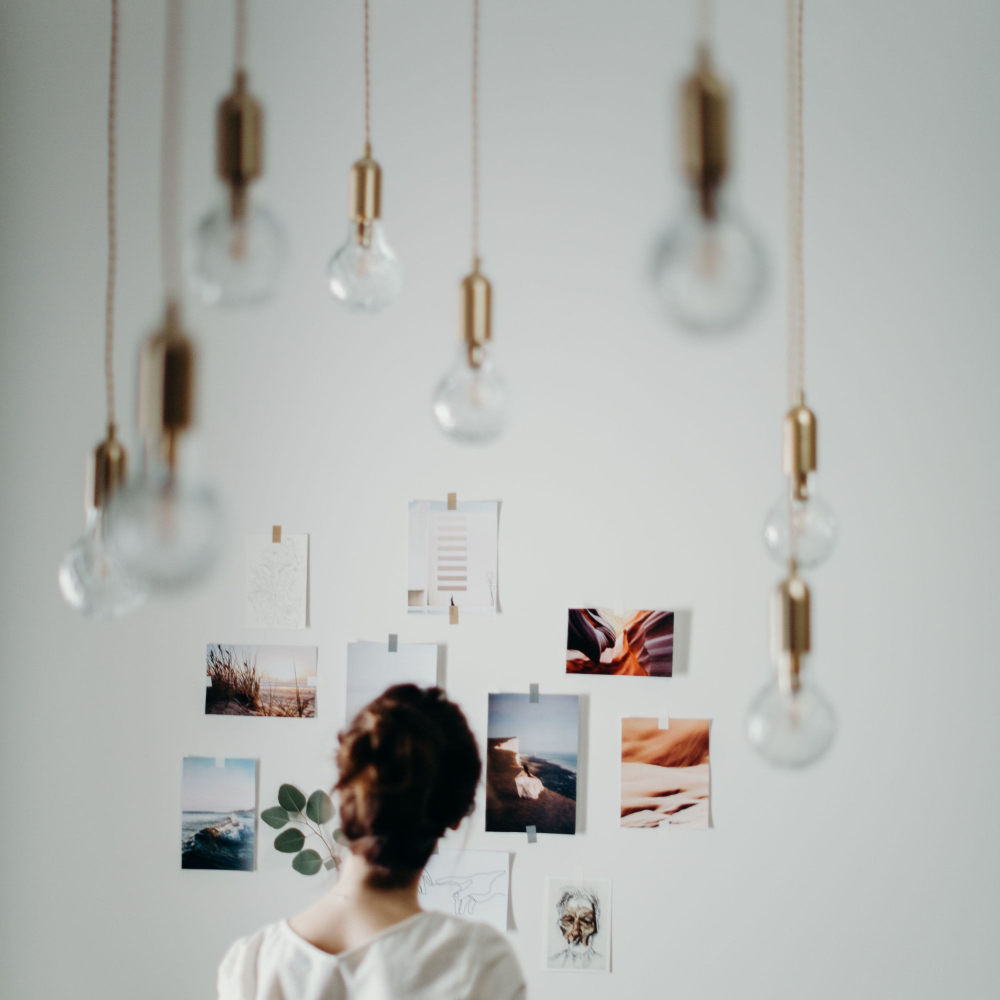 person looking at pictures on a wall