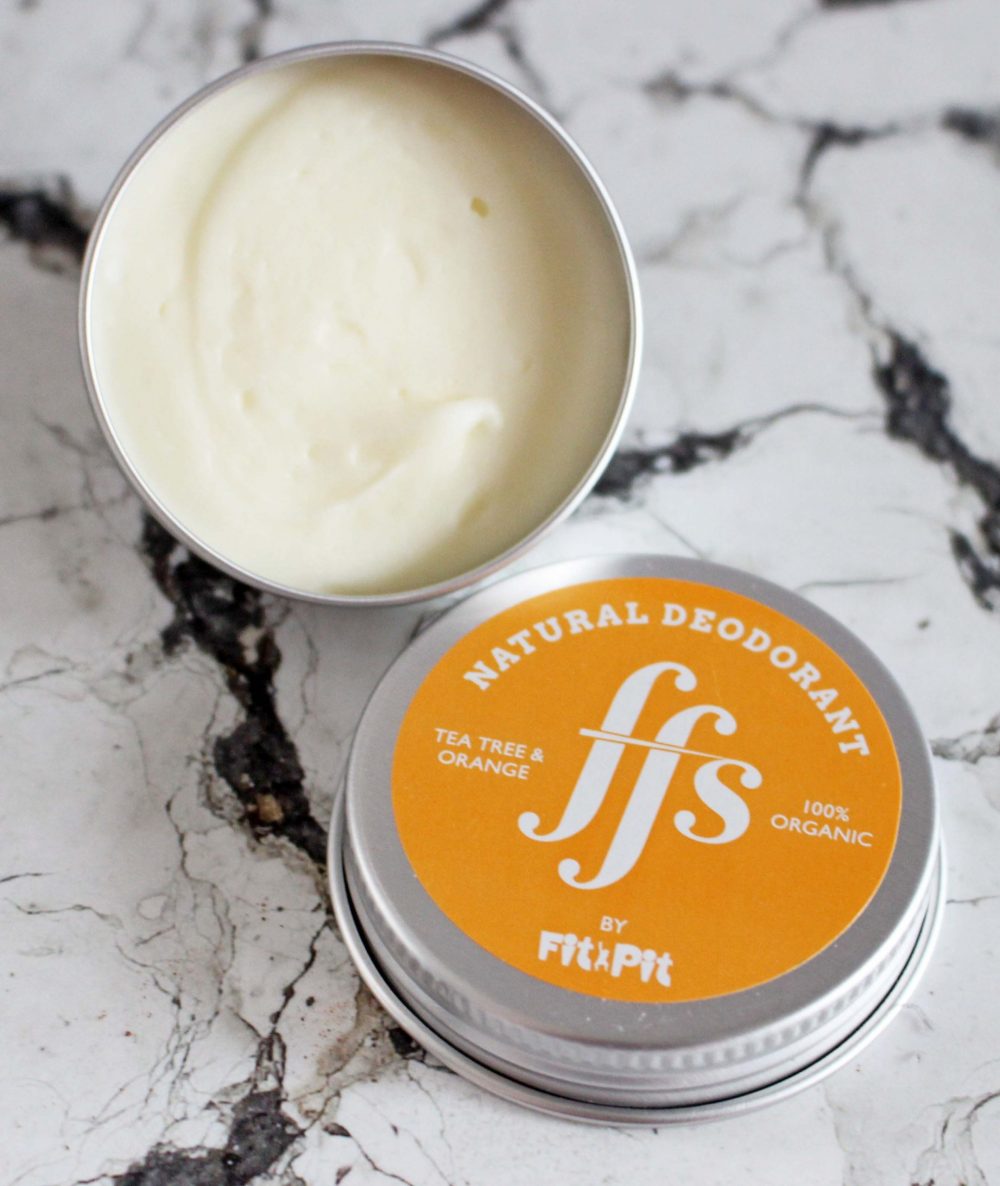 FFS Friction Free Shaving Natural Deodorant in Tea Tree and Orange over head of the pot open with lid by the side.