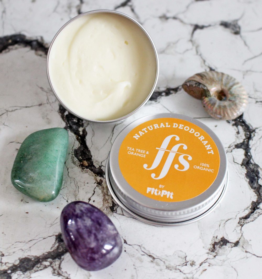 FFS Friction Free Shaving Natural Deodorant in Tea Tree and Orange over head of the pot open with lid in front.