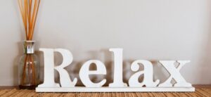 Relax Sign Next to Reed Diffuser