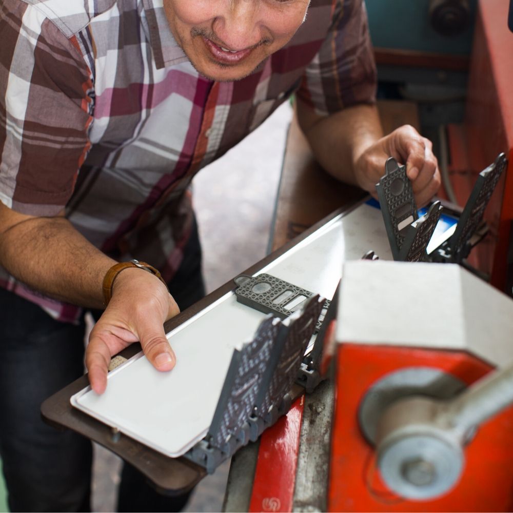 person working on making a number plate