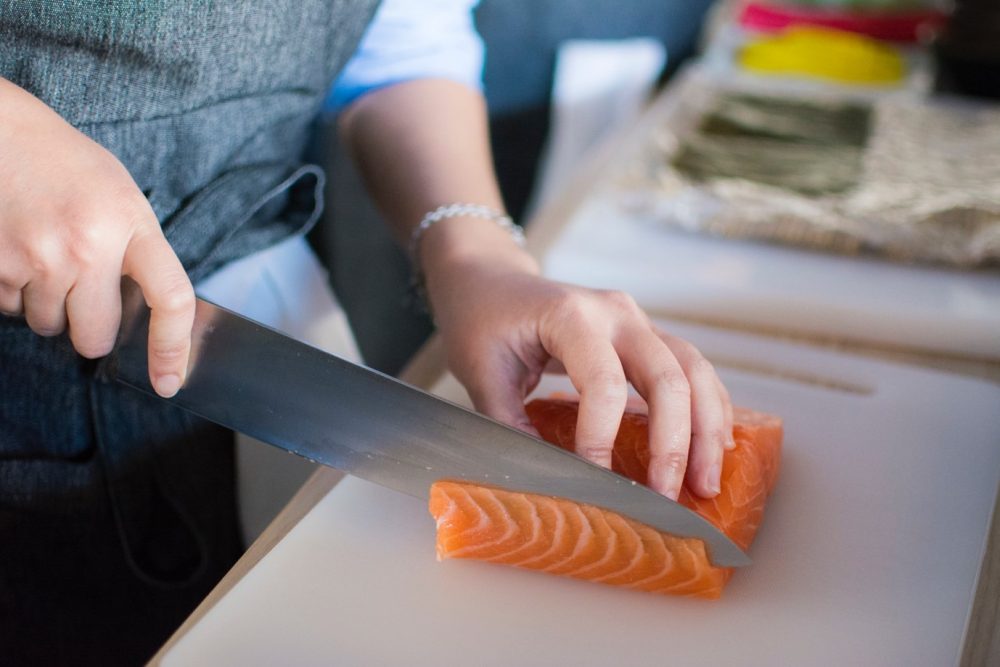 person cutting fish