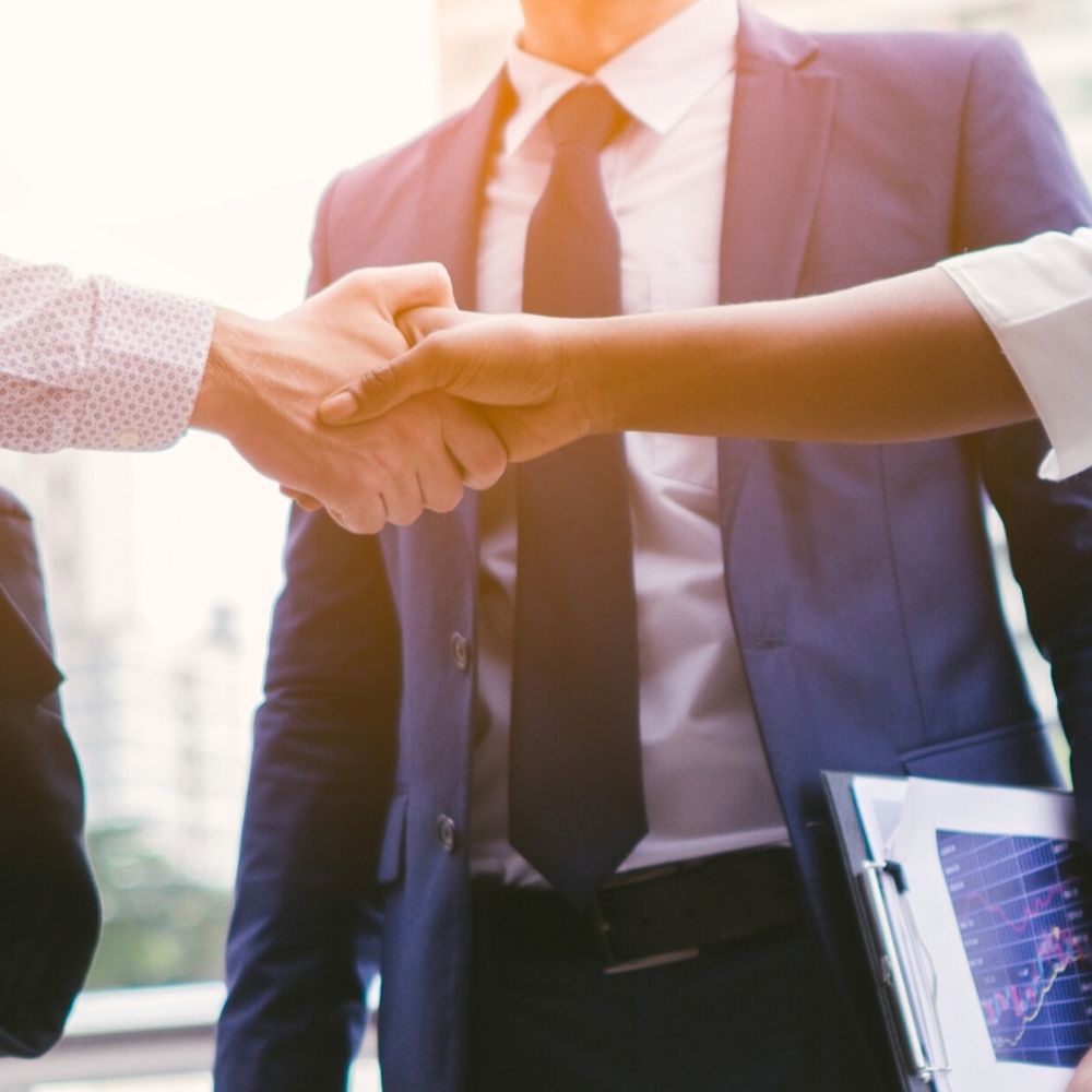 people shaking hands at a business meeting