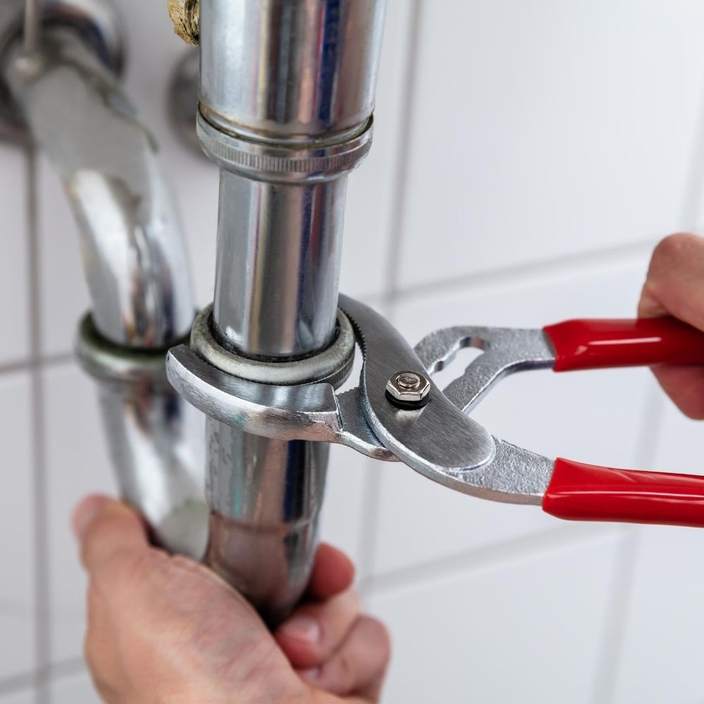 someone fixing a pipe