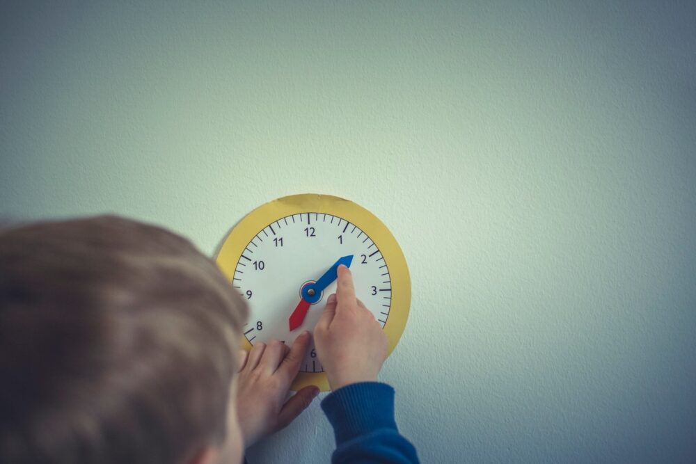 child with a clock