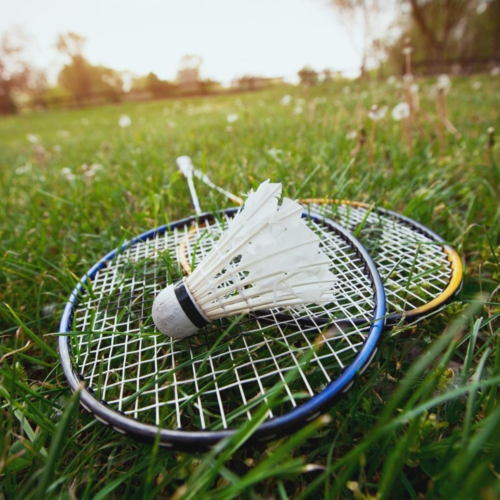 badminton rackets on grass