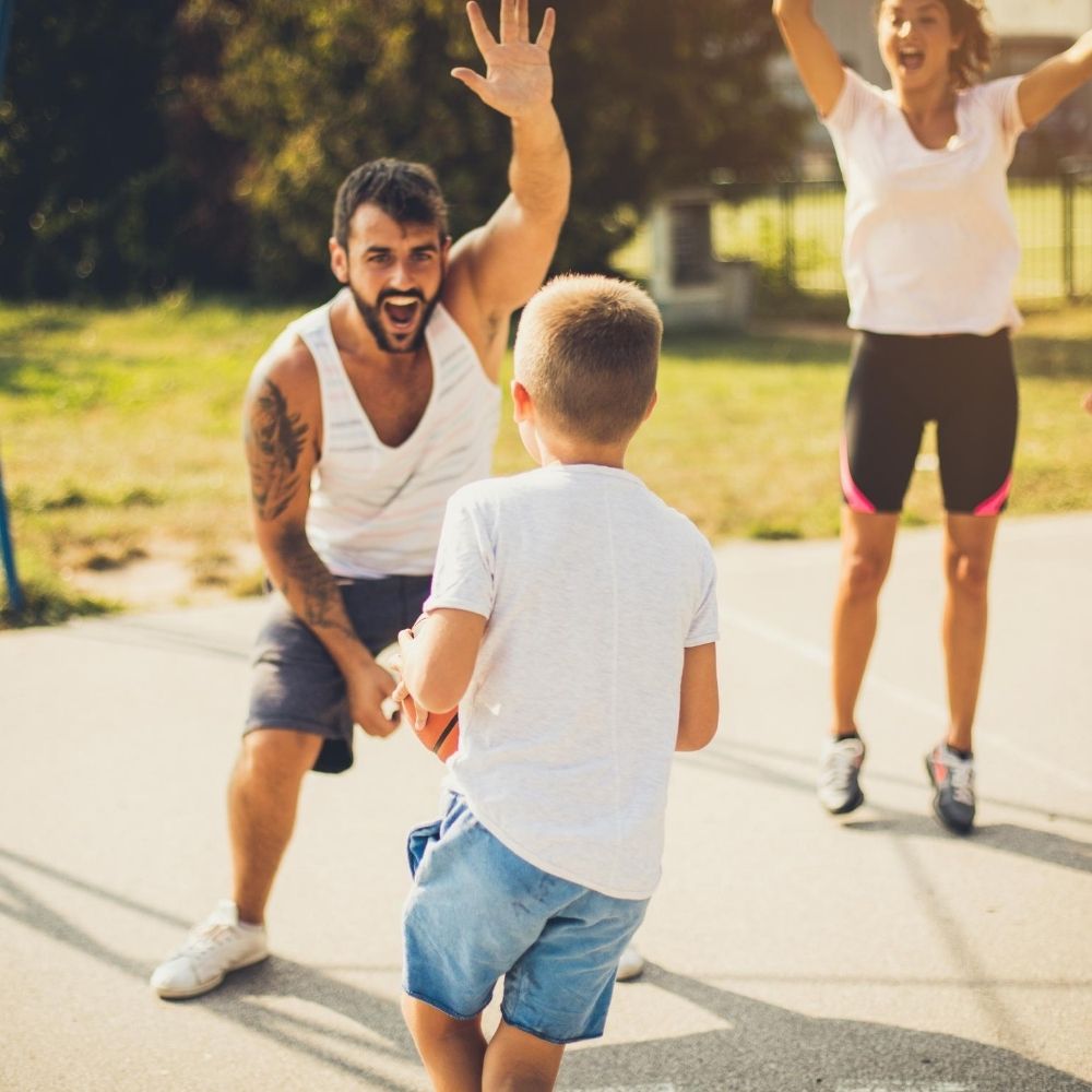 family playing sports outside