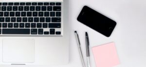 laptop phone and pens
