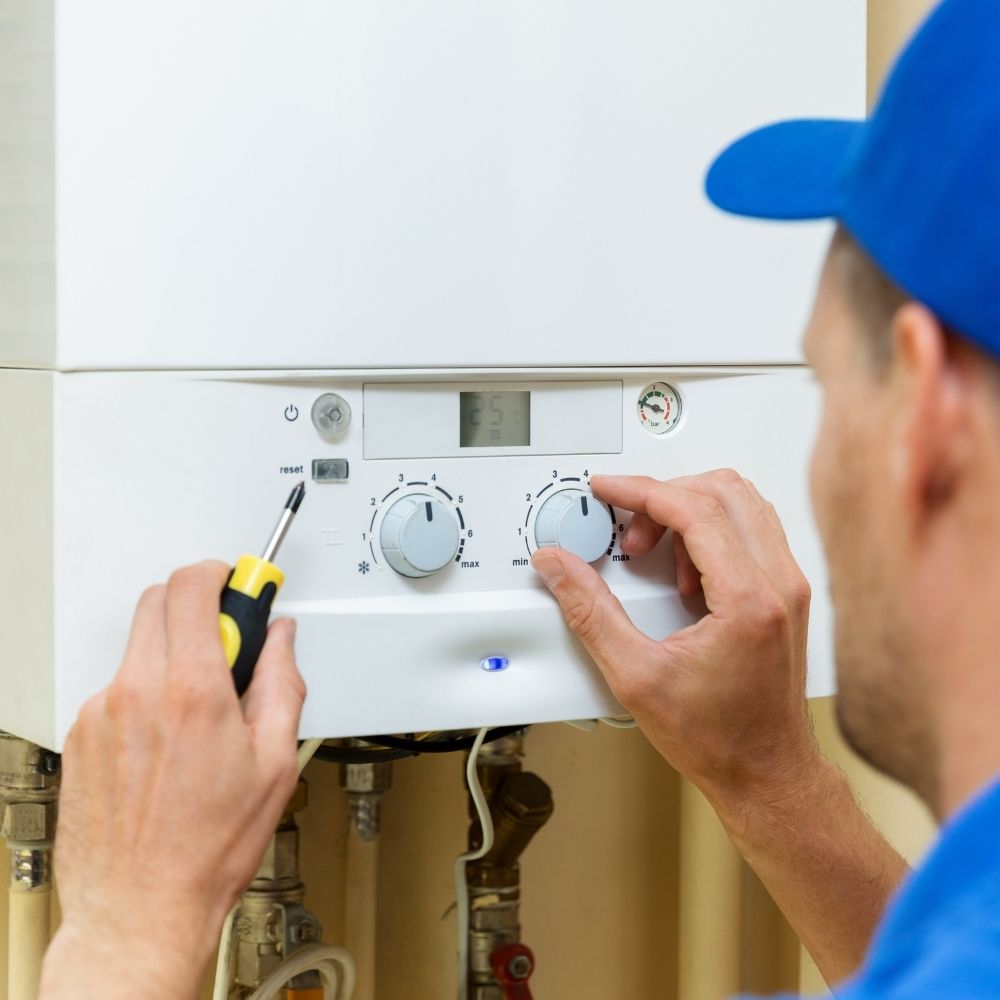 man working on a boiler