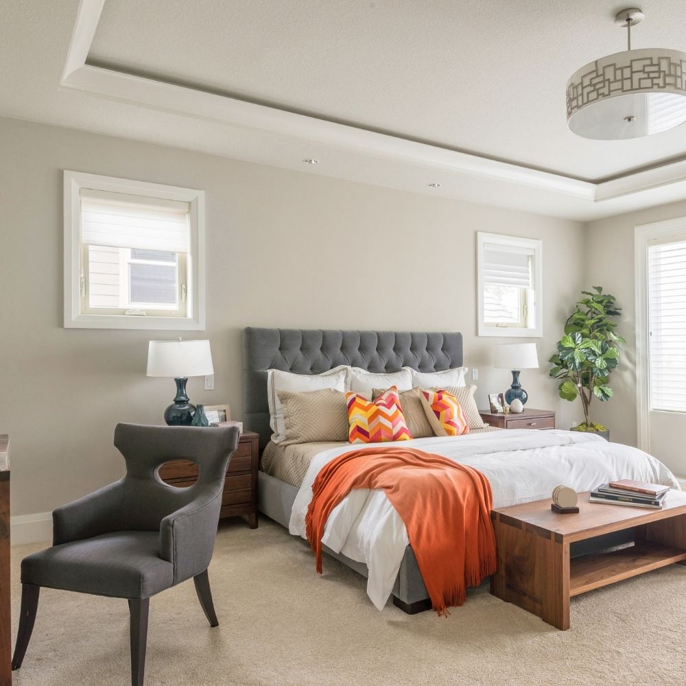 master bathroom with bed and seat area