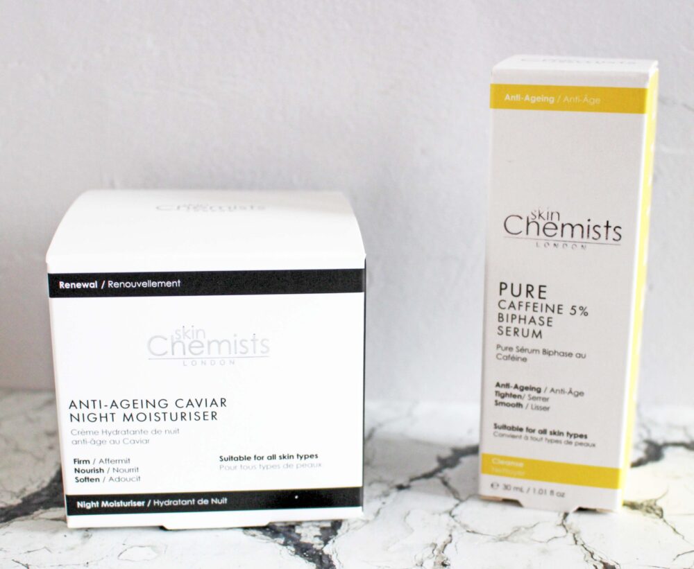 skinchemists products the Anti-Ageing Caviar Night Moisturiser on the right, it's box is white with black accents, on the left the bi-phase caffeine serum in a white box with yellow accents.