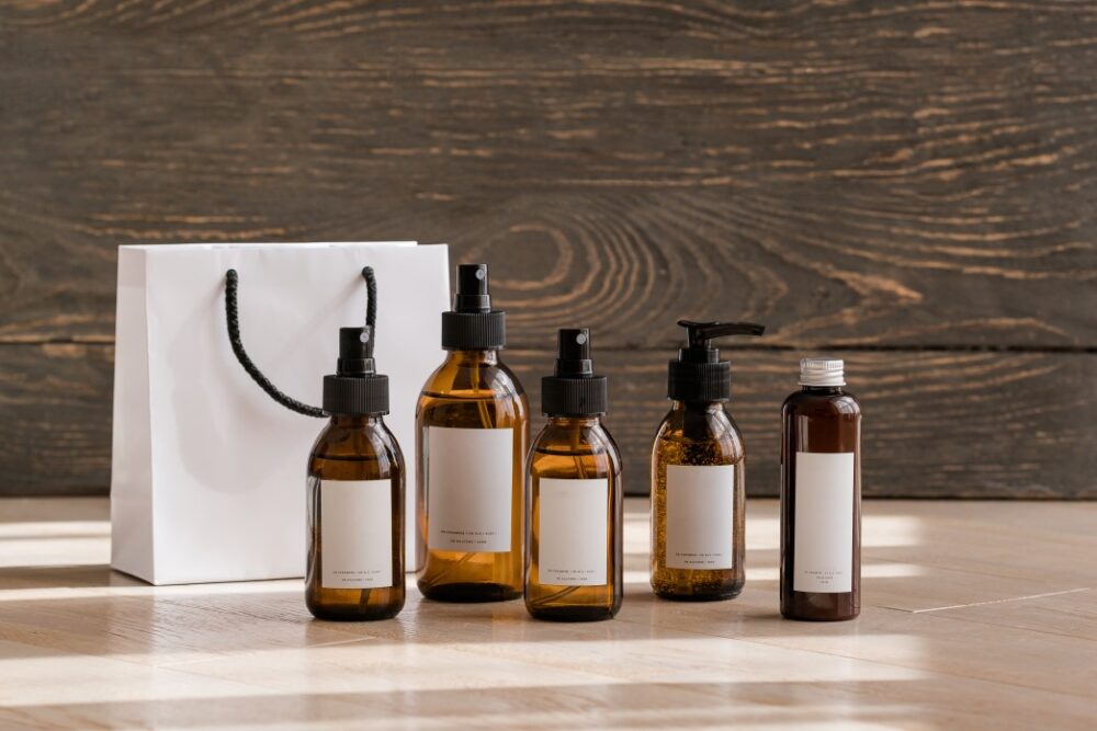 Set of cosmetic dark amber glass bottles on wooden background