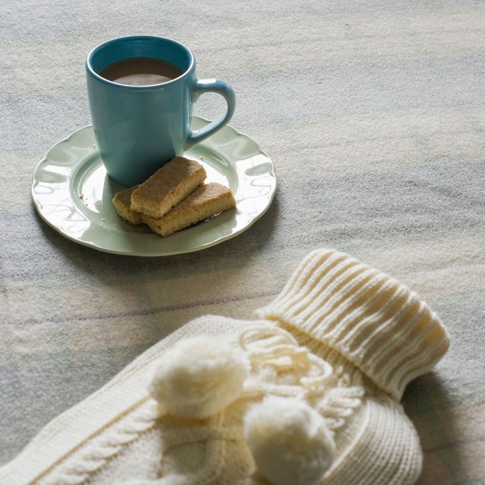 hot water bottle, coffee and biscuits
