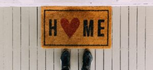 door mat with home on it and shoes