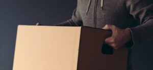 person holding a packed cardboard box