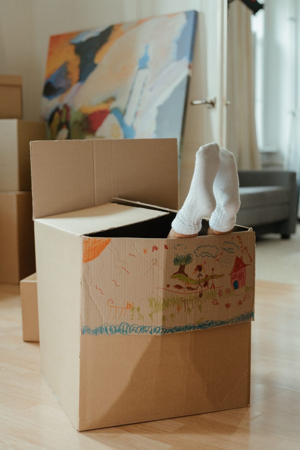 Persons feet sticking out of a cardboard box