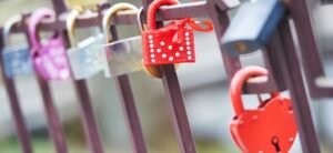 row of colourful padlocks on a fence