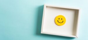a happy face inside a box on a blue background