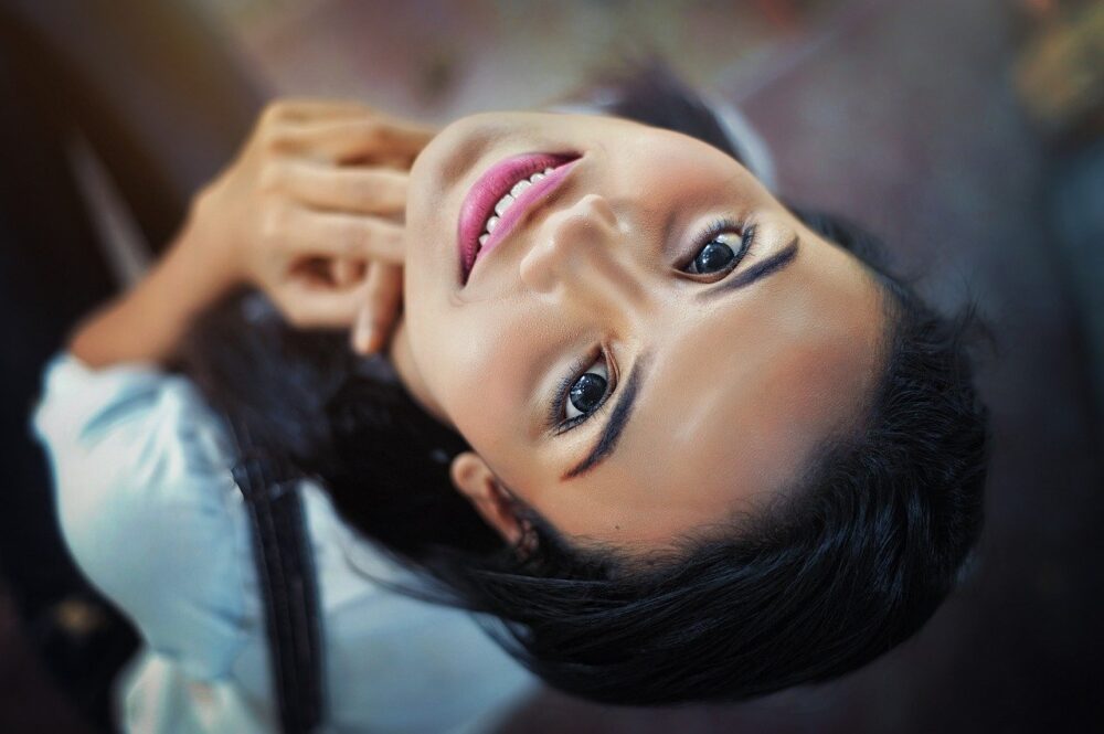 Image of a women with black hair and brown eyes looking up at a camera
