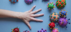hand surrounded by viruses