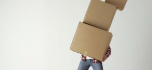 man carrying multiple boxes