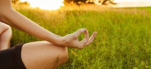 person meditating in the countryside