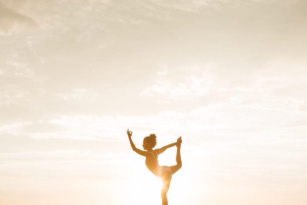 Women practicing yogo outside at the golden hour