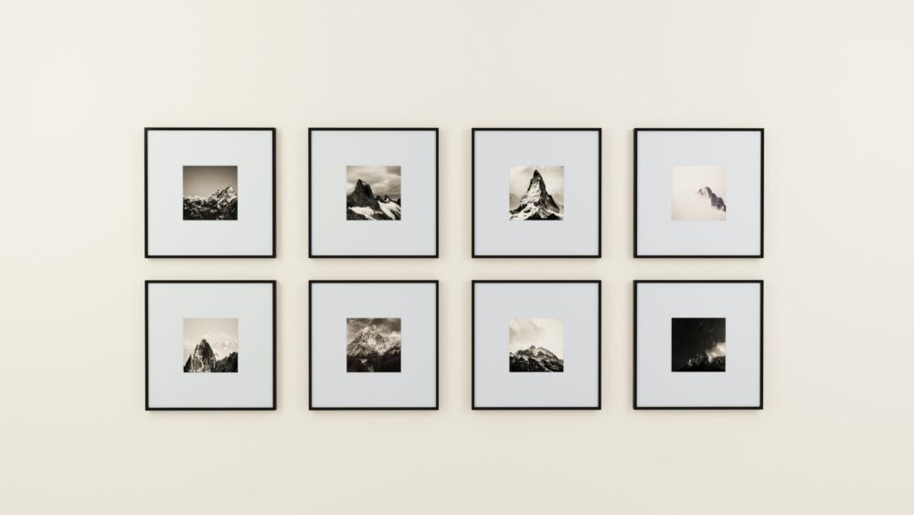 Gallery Wall of monochrome images of mountains on a cream coloured wall