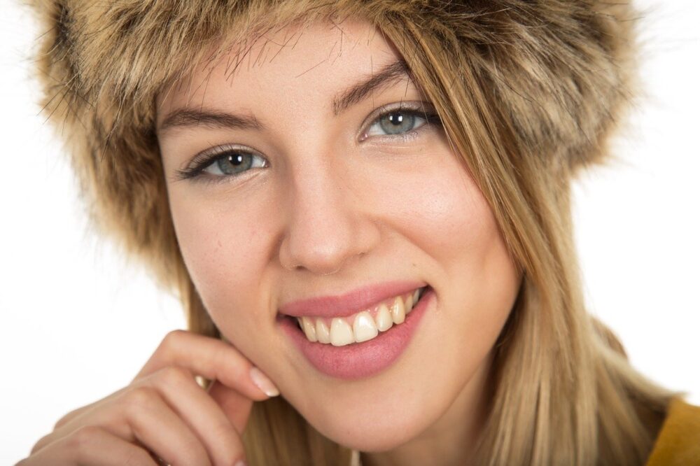 women with blond hair smiling at the camera